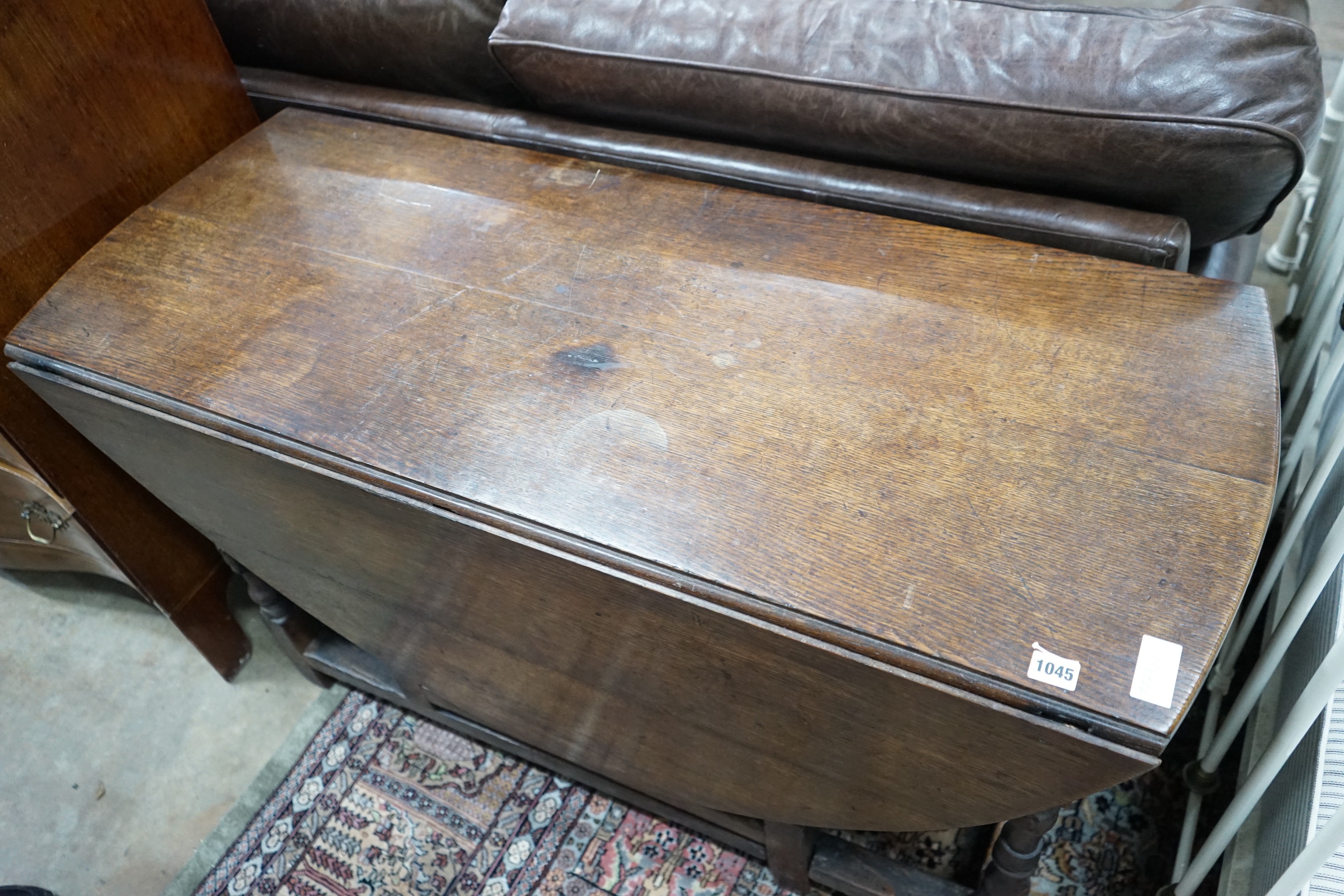 An 18th century oak gateleg dining table, length 141cm extended, width 120cm, height 74cm